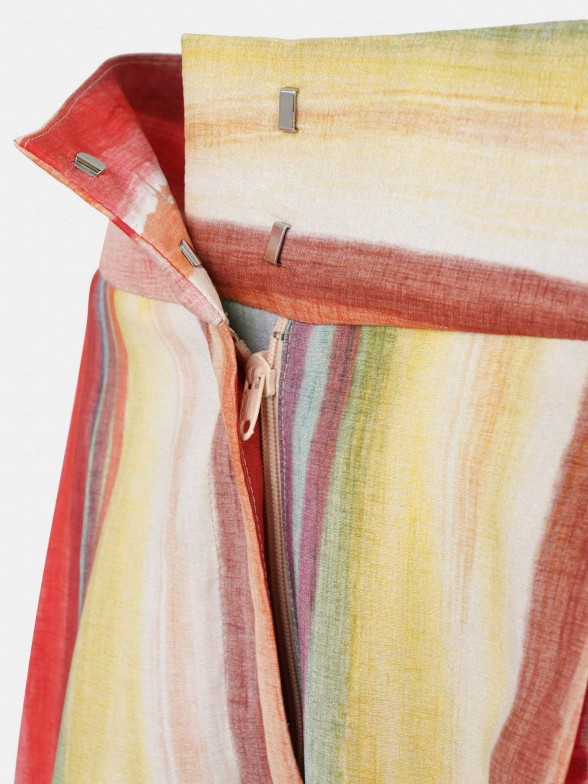 Woman's flowing trousers with colourful stripe pattern