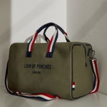 Man's green bag in twill with tricolour handle