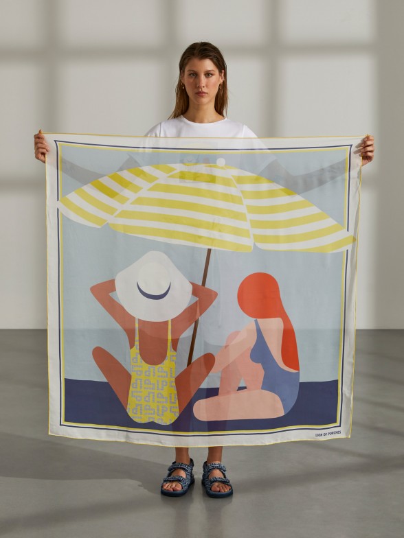 Woman's blue silk scarf printed with beach motifs