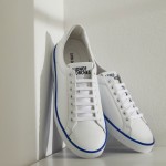 Man's white leather trainers with branding on the sole