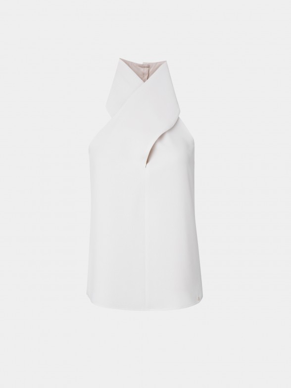 Woman's white sleeveless top with cross neckline