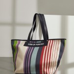 Woman's cotton and leather bag with colourful stripe pattern 