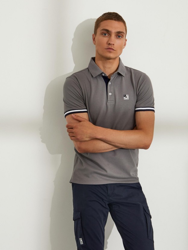Man's slim fit cotton polo shirt with stripes on the sleeves
