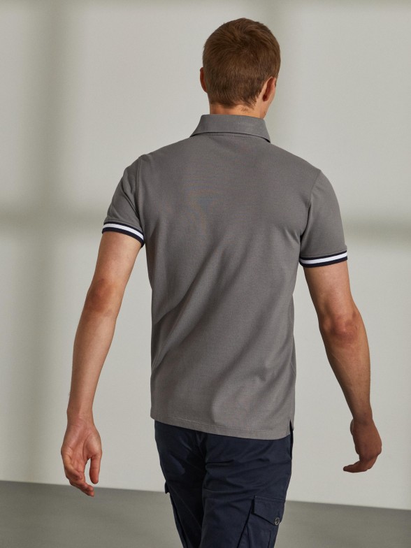 Man's slim fit cotton polo shirt with stripes on the sleeves