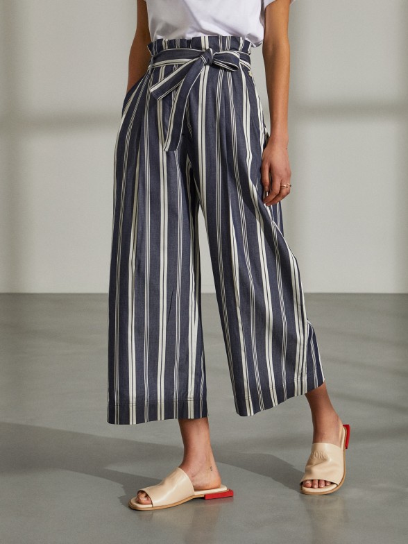 Woman's trousers paper bag with stripes and belt